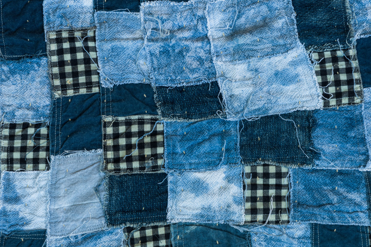 Denim squares loosely sewed together into a blanket